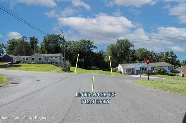 a view of a tennis ground with a large trees