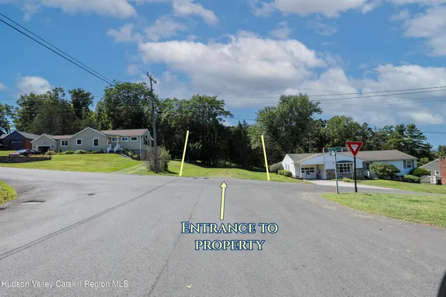a view of a tennis ground with a large trees