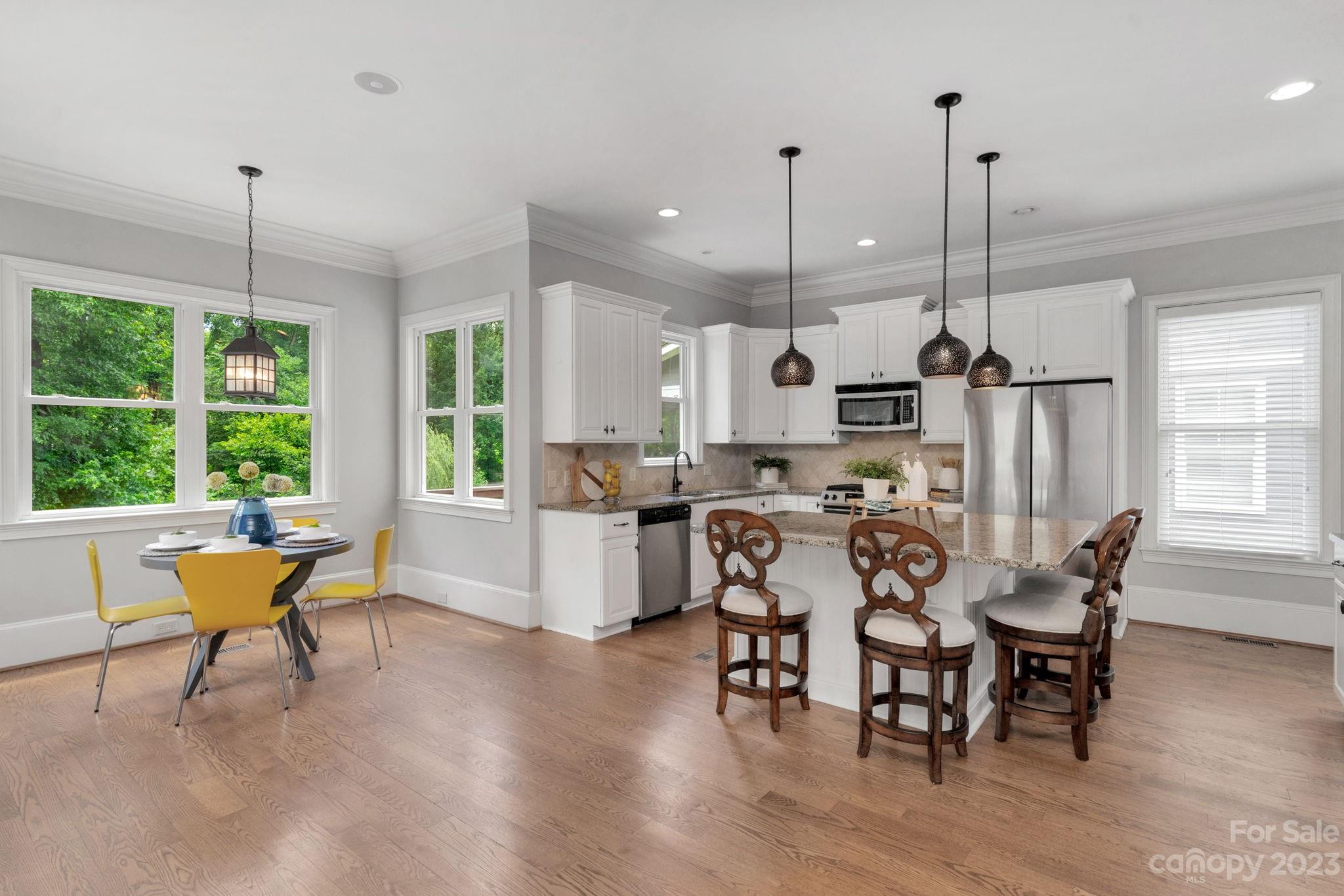 1320 Ivey Drive Charlotte, NC 28205 - Photo 14 of 45 a view of a dining room and livingroom with furniture wooden floor a chandelier