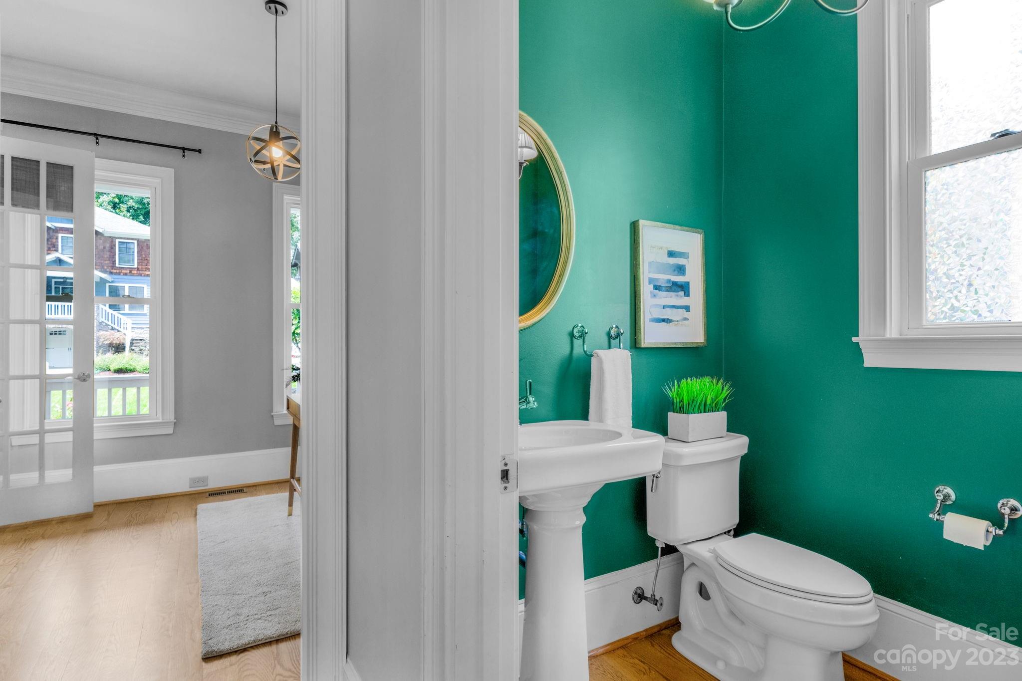 1320 Ivey Drive Charlotte, NC 28205 - Photo 21 of 45 a white toilet sitting next to a bathroom sink and a window