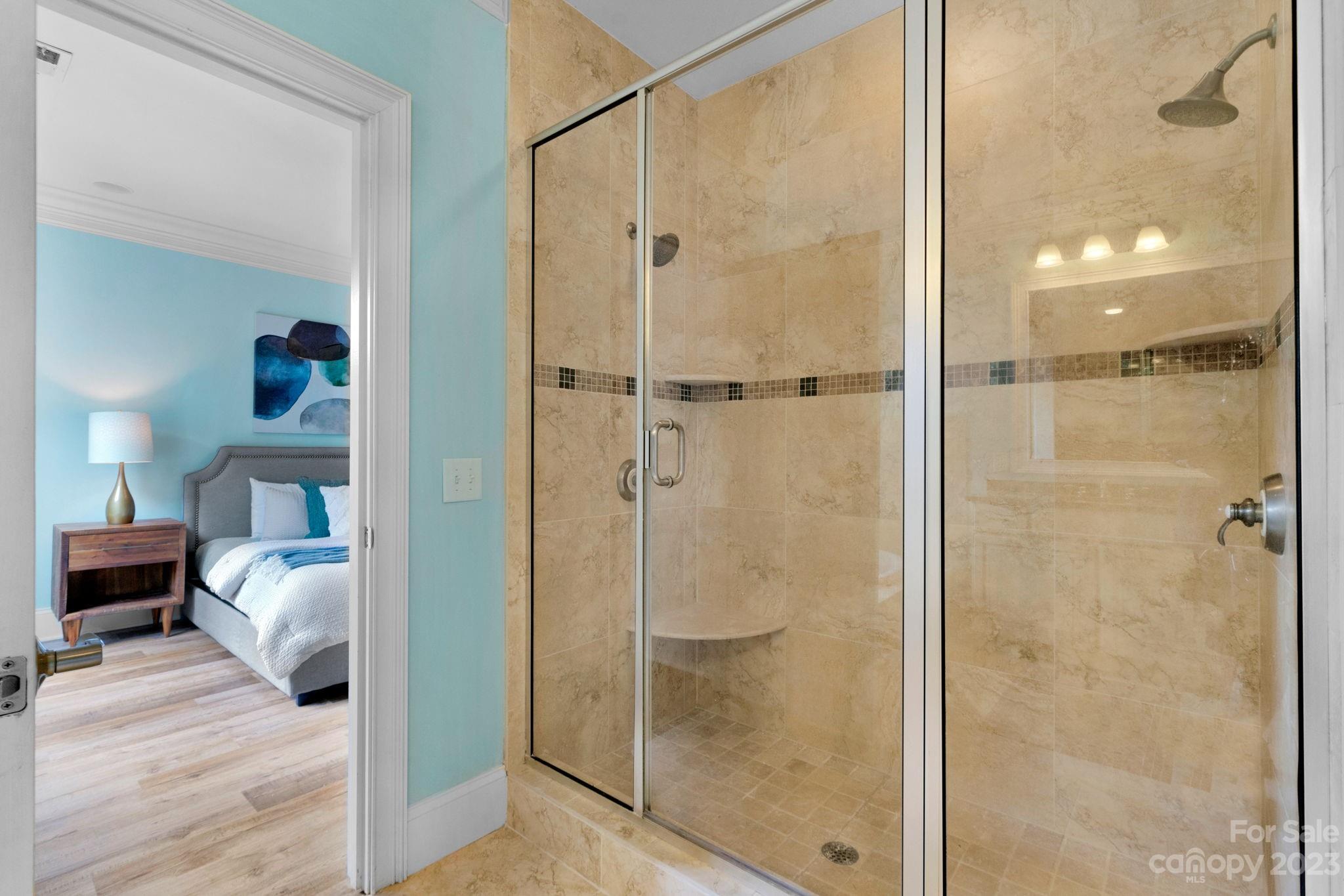 1320 Ivey Drive Charlotte, NC 28205 - Photo 25 of 45 a bathroom with a glass shower door