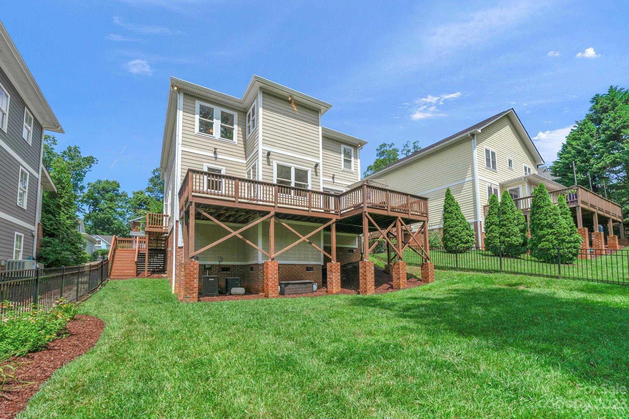 1320 Ivey Drive Charlotte, NC 28205 - Photo 37 of 45 a view of a house with a big yard and large trees