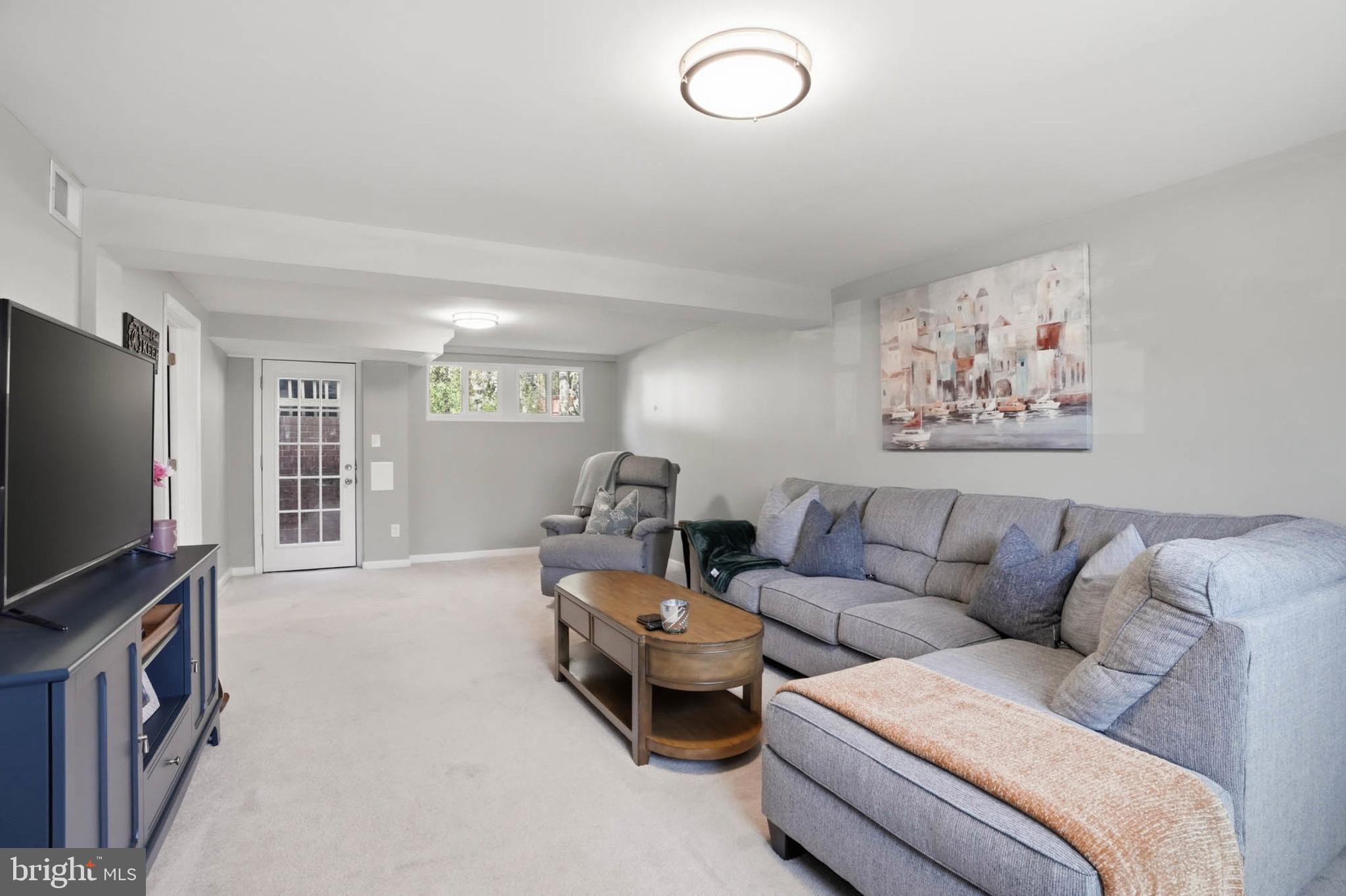 810 Venice Drive Silver Spring, MD 20904 - Photo 20 of 33 a living room with furniture and a flat screen tv