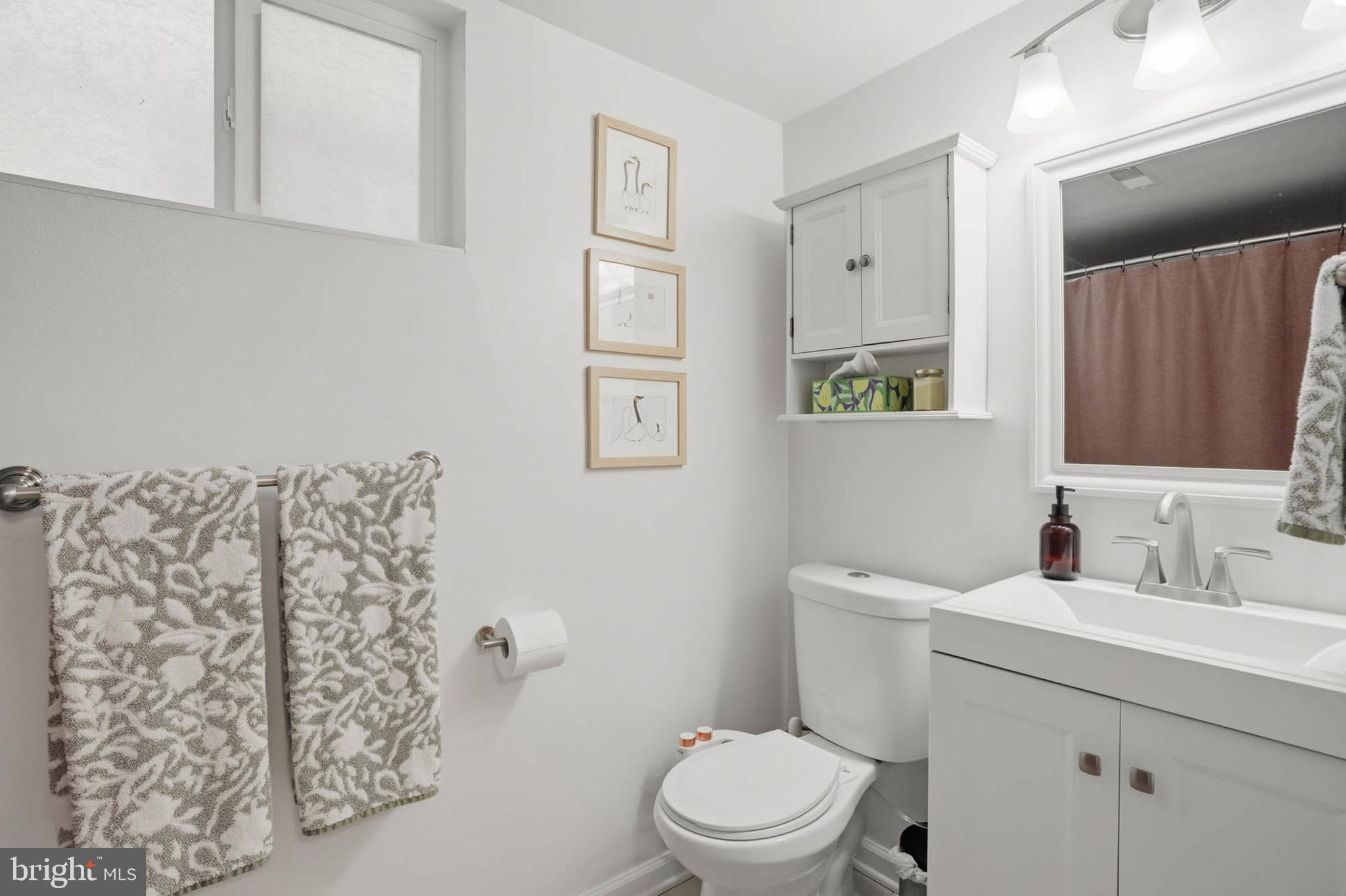 810 Venice Drive Silver Spring, MD 20904 - Photo 26 of 33 a bathroom with a toilet sink vanity and mirror