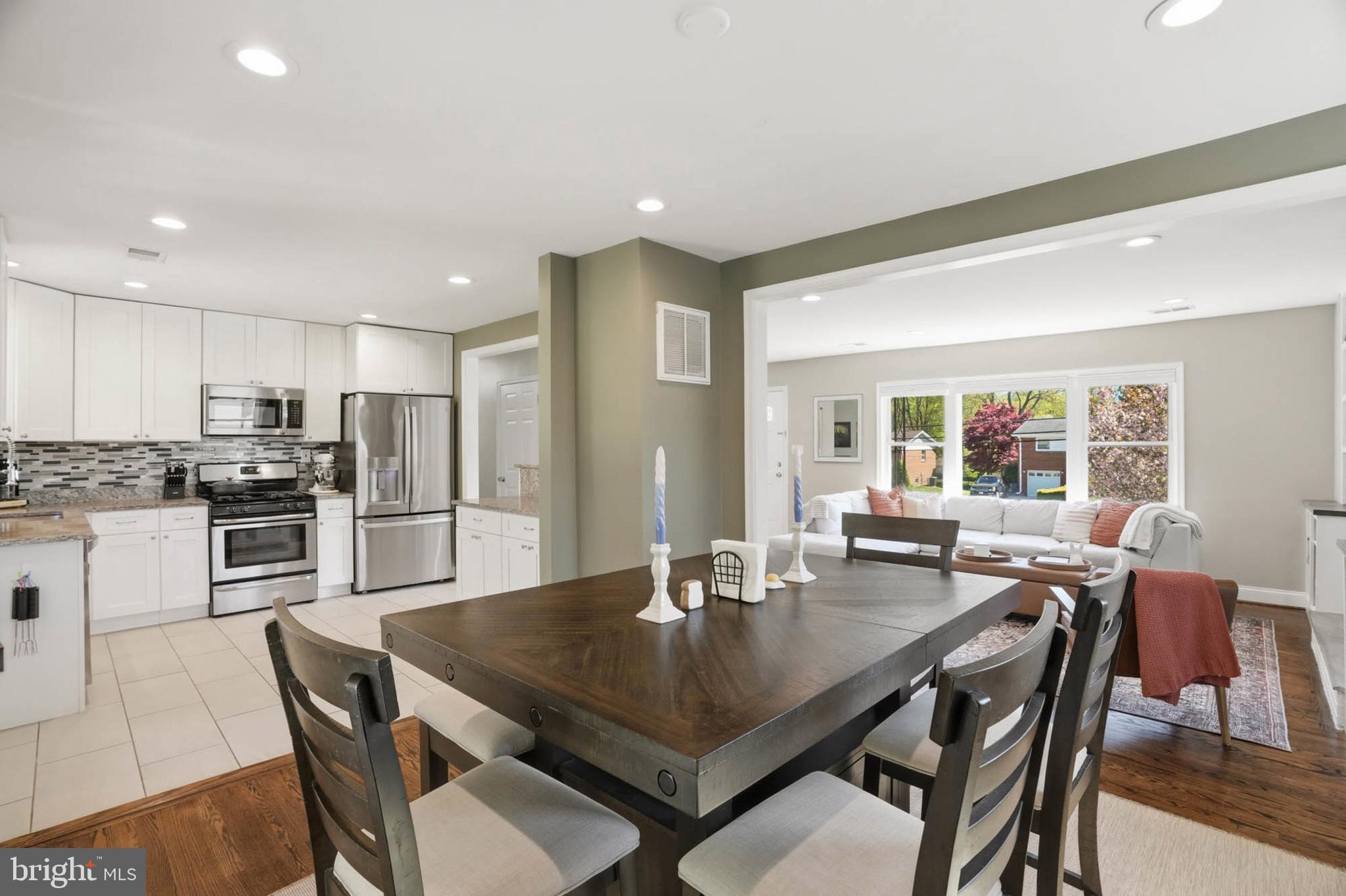 810 Venice Drive Silver Spring, MD 20904 - Photo 8 of 33 a kitchen with a dining table chairs and refrigerator