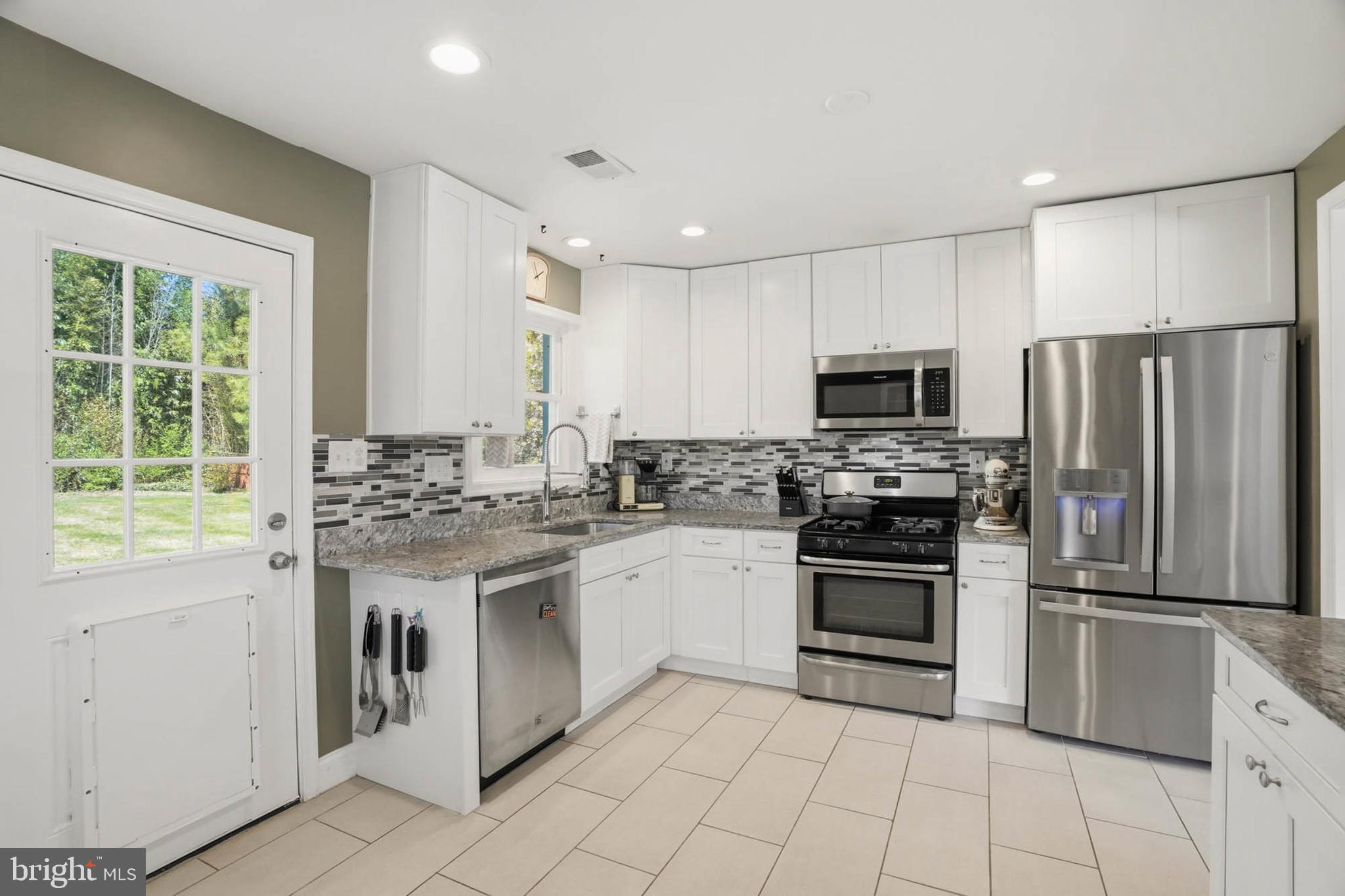 810 Venice Drive Silver Spring, MD 20904 - Photo 9 of 33 a kitchen with a sink stainless steel appliances and cabinets