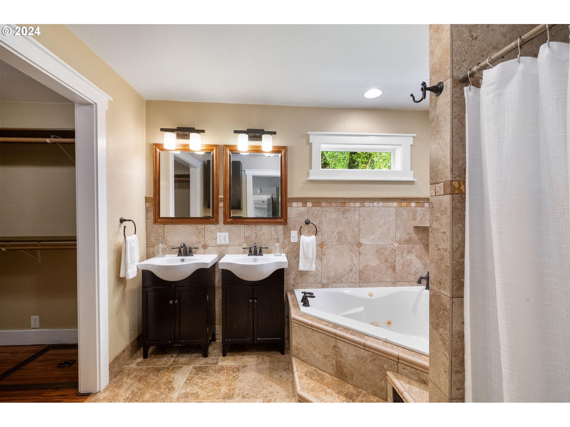 8511 Southeast Barbara Welch Road Portland, OR 97236 - Photo 12 of 30 a bathroom with a tub sink and mirror