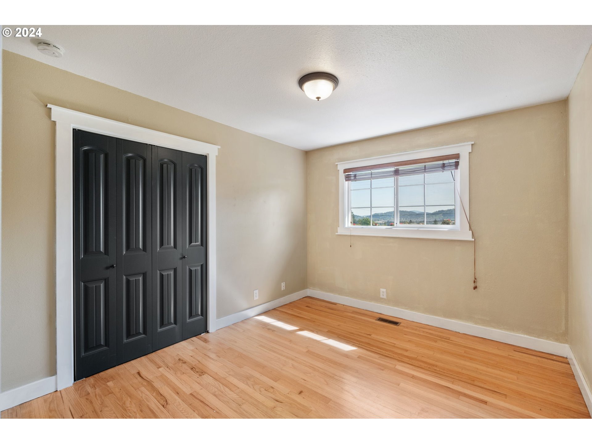 8511 Southeast Barbara Welch Road Portland, OR 97236 - Photo 17 of 30 a view of an empty room with wooden floor