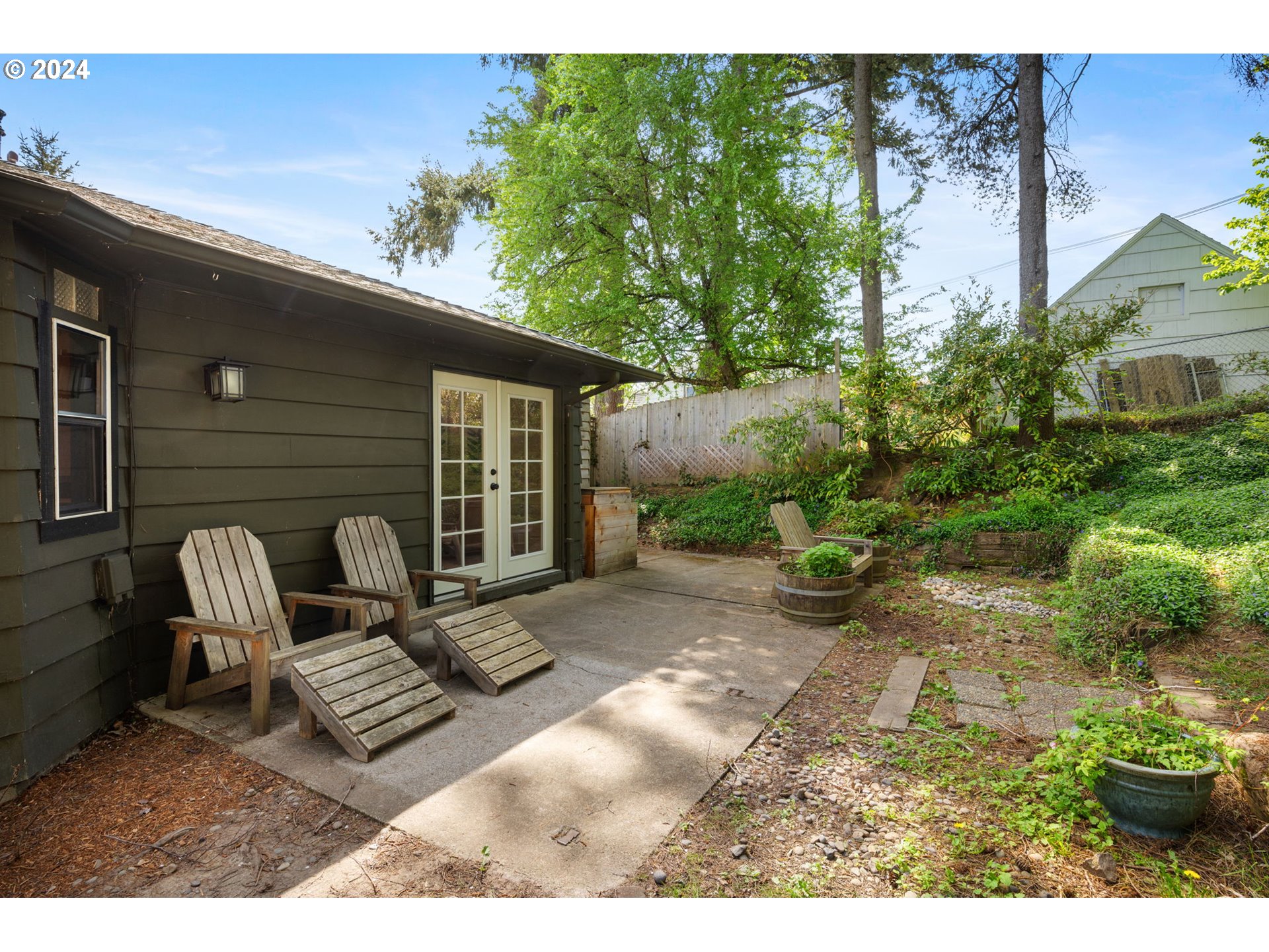 8511 Southeast Barbara Welch Road Portland, OR 97236 - Photo 23 of 30 a view of a patio with table and chairs and potted plants