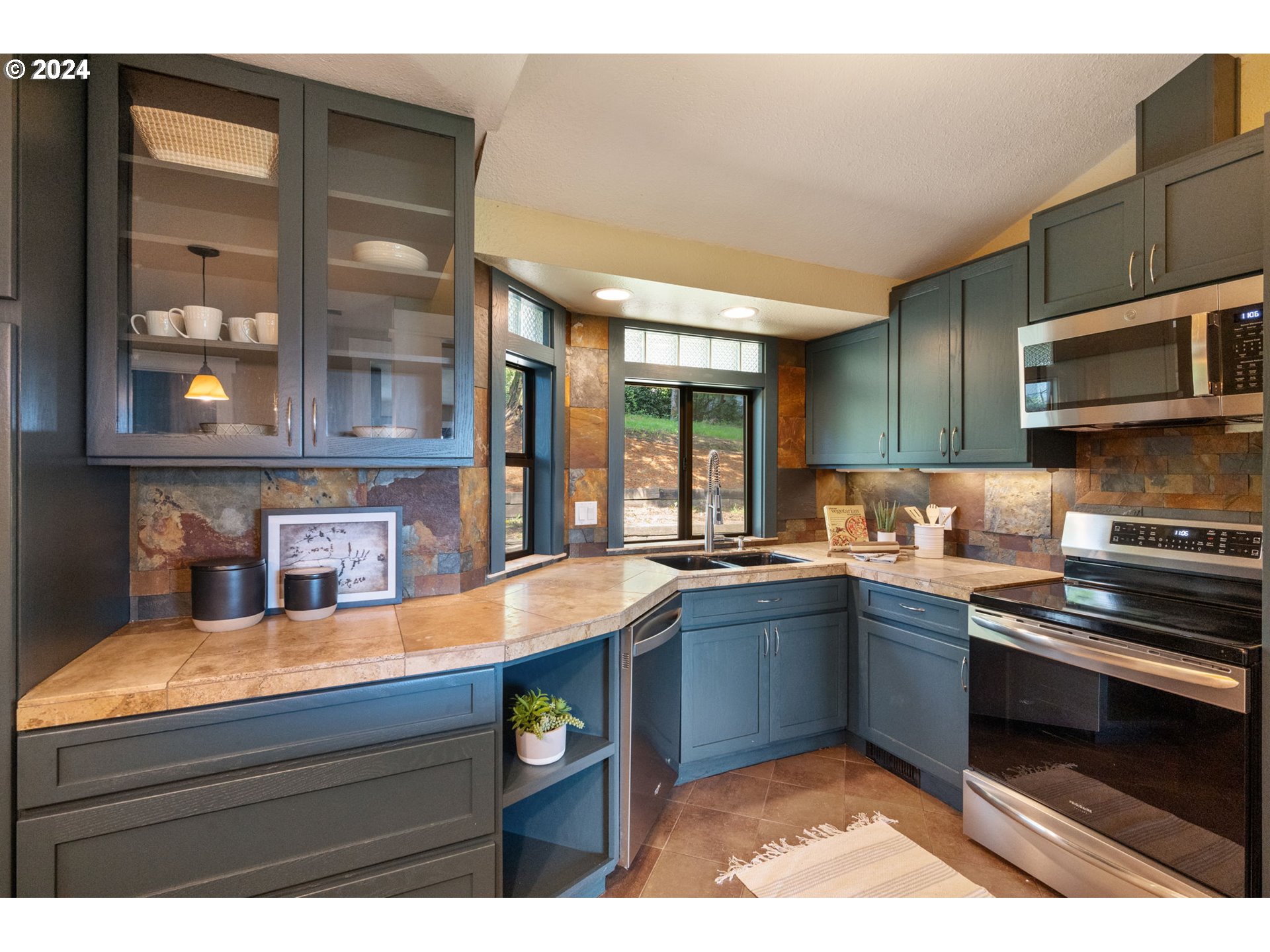 8511 Southeast Barbara Welch Road Portland, OR 97236 - Photo 6 of 30 a kitchen with a sink and cabinets