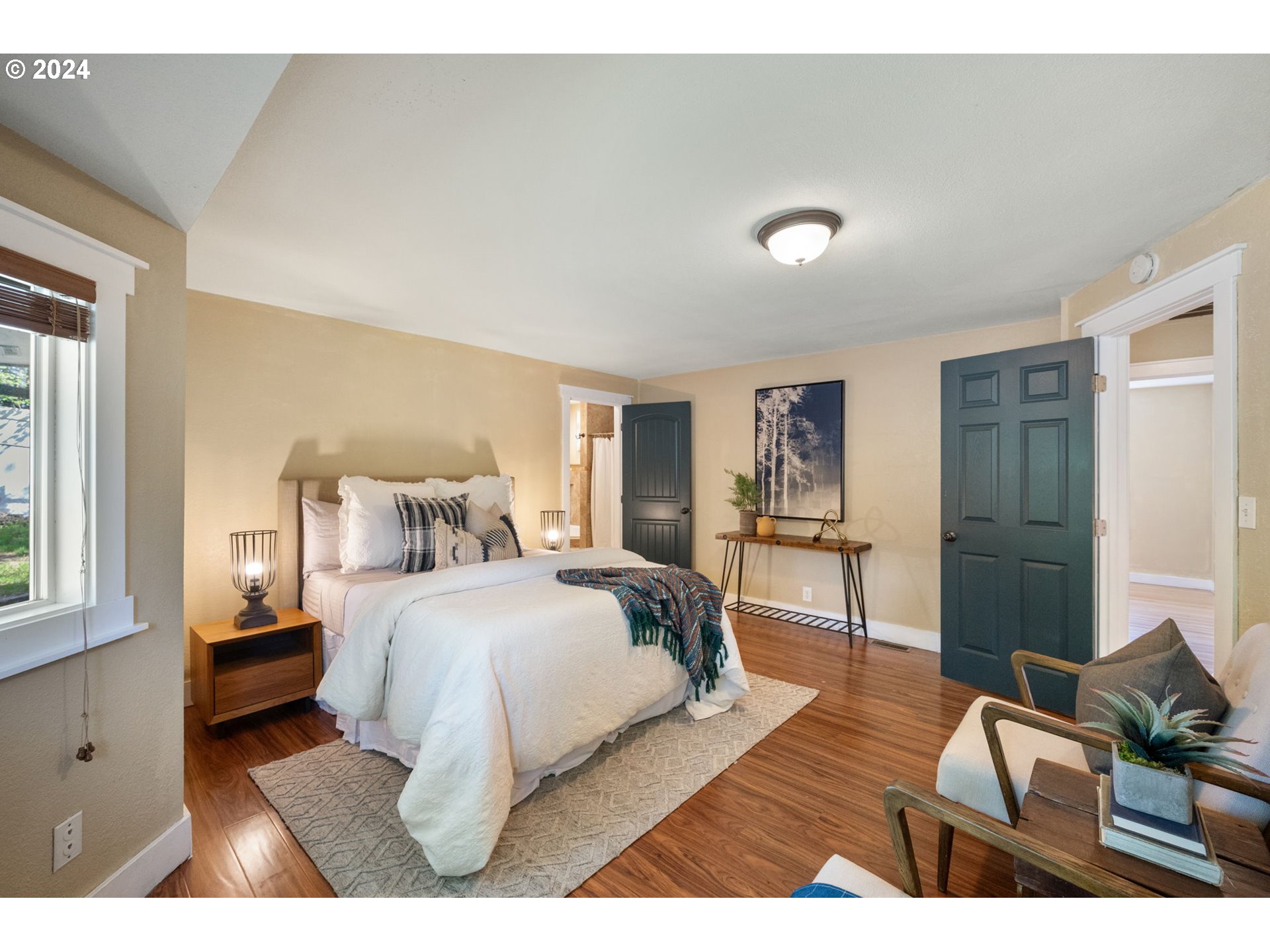 8511 Southeast Barbara Welch Road Portland, OR 97236 - Photo 9 of 30 a bedroom with a bed and wooden floor