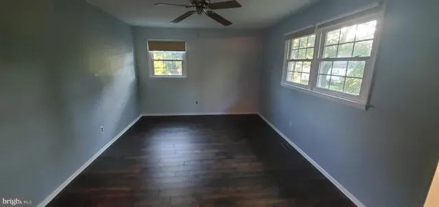 a view of a small space with wooden floor and a window