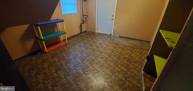 a backyard of a house with large trees and plants