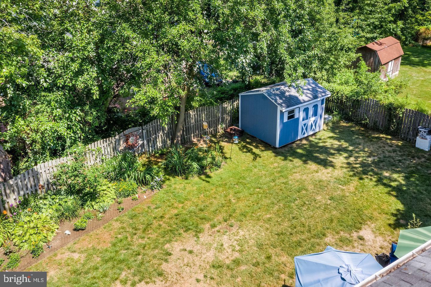 5 Crider Avenue Moorestown, NJ 08057 - Photo 64 of 64 a backyard of a house with large trees and plants