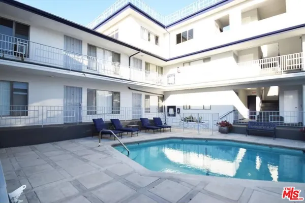 a view of a house with swimming pool and sitting area