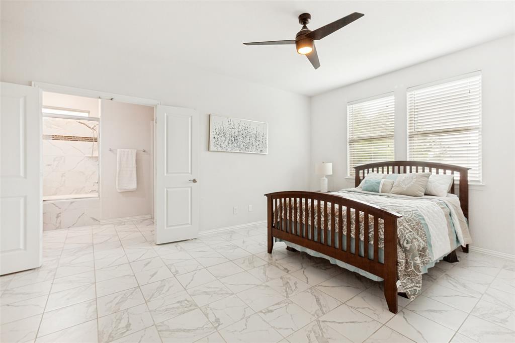 605 Ansley Way Allen, TX 75013 - Photo 18 of 28 Spacious room featuring white walls, large format marble-look tile flooring, and a contemporary ceiling fan