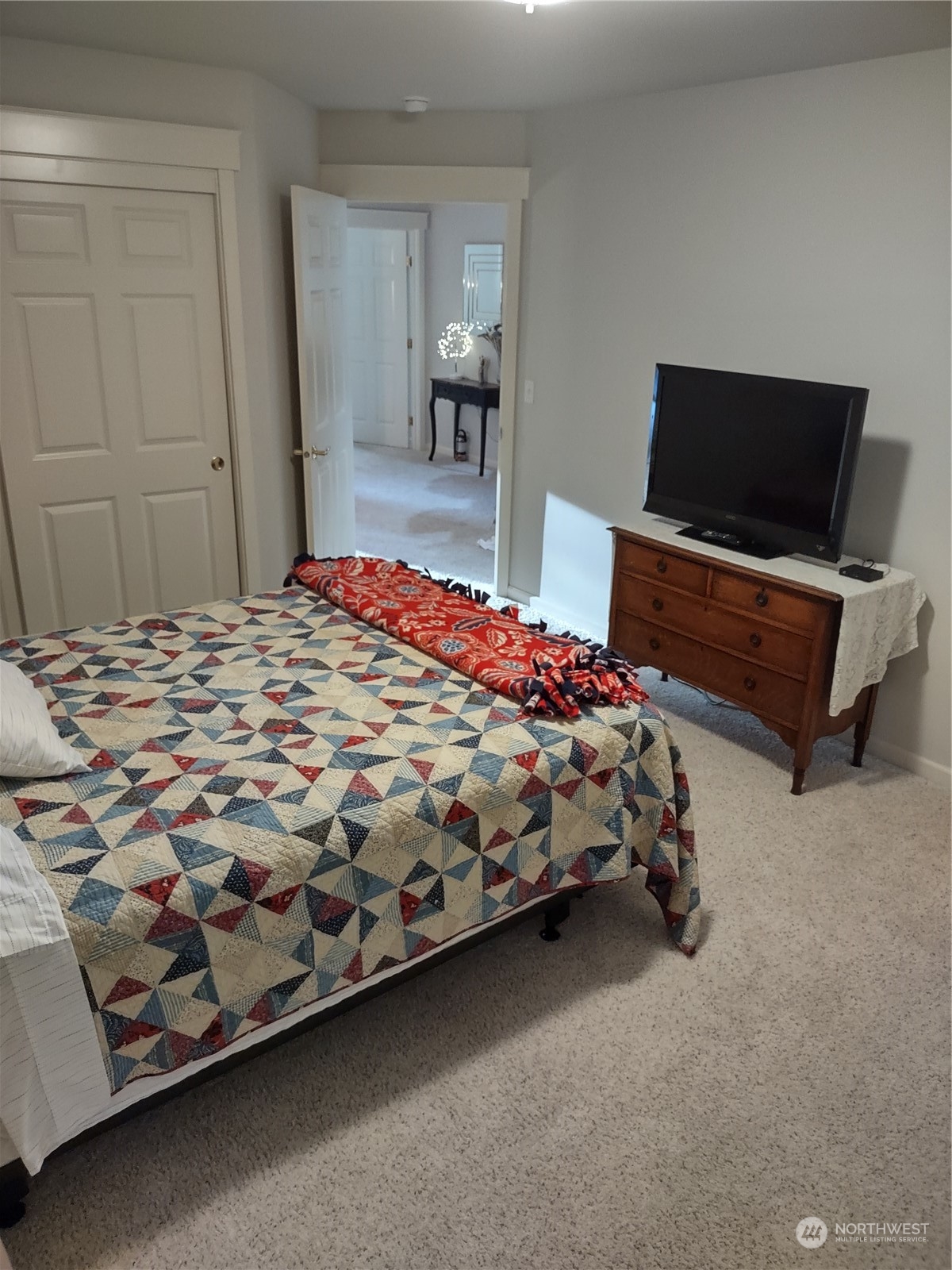 160 East Soderberg Road, Unit G19 Allyn, WA 98524 - Photo 17 of 38 a bedroom with a bed and a flat screen tv