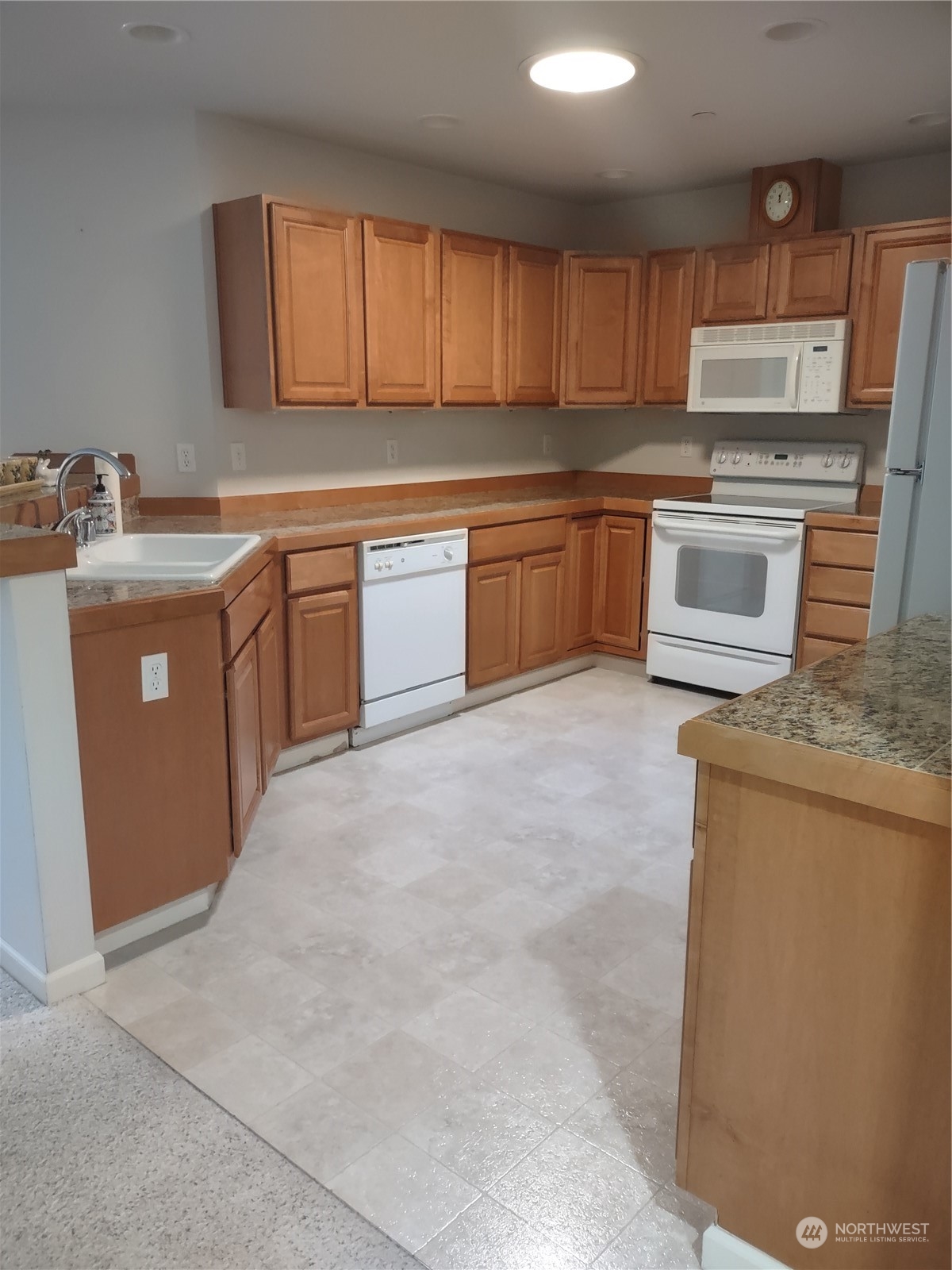 160 East Soderberg Road, Unit G19 Allyn, WA 98524 - Photo 9 of 38 a kitchen with sink a microwave a stove and cabinets