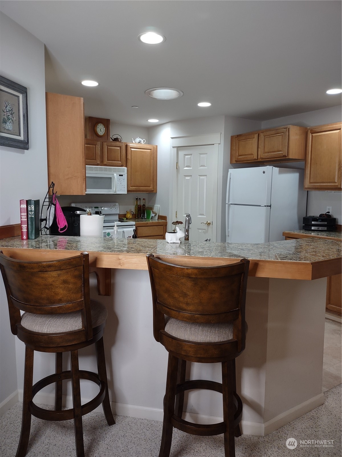 160 East Soderberg Road, Unit G19 Allyn, WA 98524 - Photo 10 of 38 a kitchen with a table chairs sink and cabinets