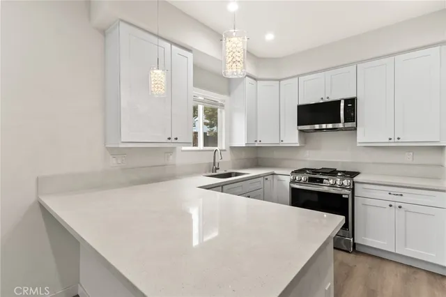 a kitchen with a sink a stove and cabinets