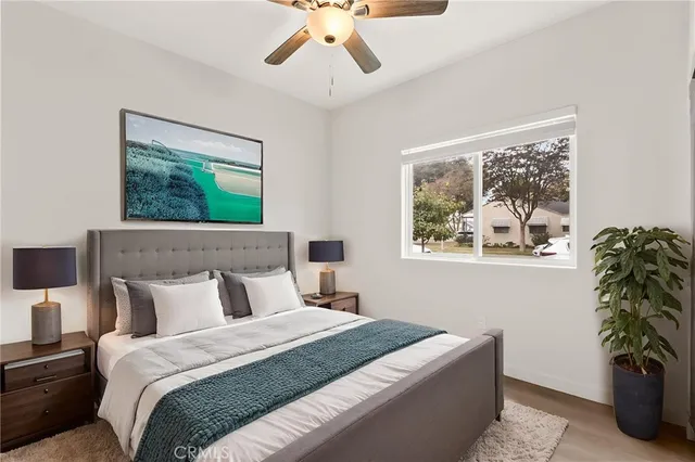 a bedroom with bed and a window