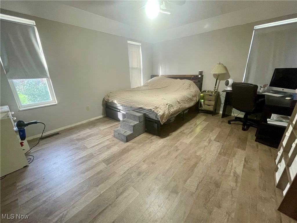 7990 Quarry Road Amherst, OH 44001 - Photo 12 of 29 Bedroom with ceiling fan and light wood-type flooring