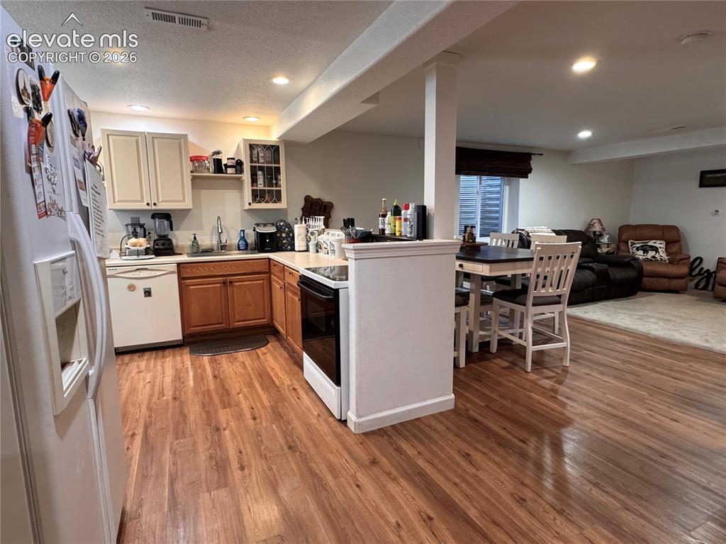 9362 St.George Road Peyton, CO 80831 - Photo 19 of 32 a kitchen with wooden floors and appliances