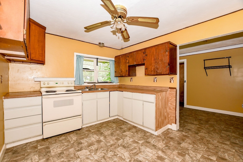 6 Gilbert Way Wareham, MA 02571 - Photo 16 of 41 a kitchen with granite countertop a sink cabinets stainless steel appliances and a counter top space