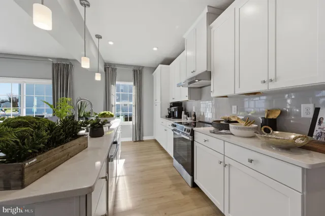 a kitchen with sink stove and cabinets