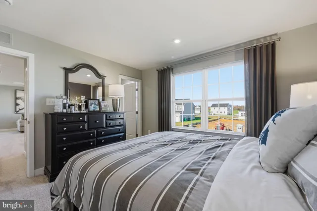 a bedroom with a bed and a large window