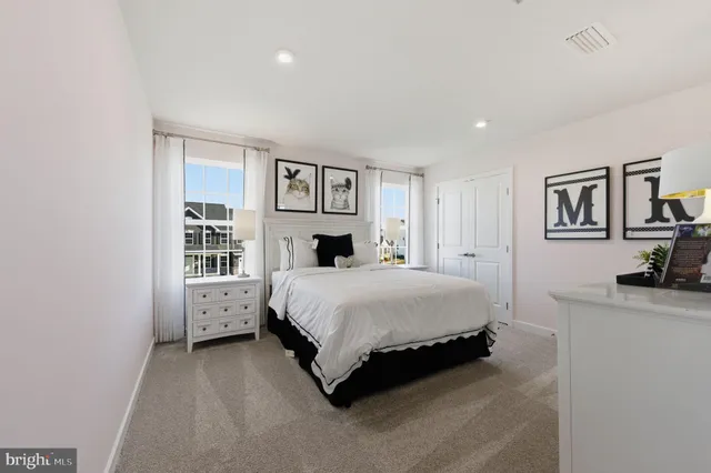 a spacious bedroom with a bed and a flat screen tv