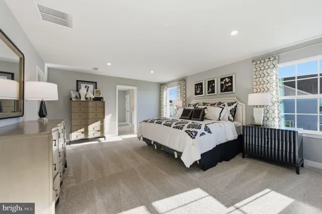 a spacious bedroom with a bed and a window