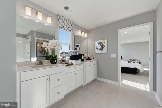 a spacious bathroom with a double vanity sink and a mirror