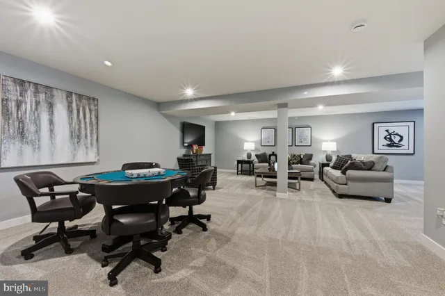 a living room with furniture a rug and a projector