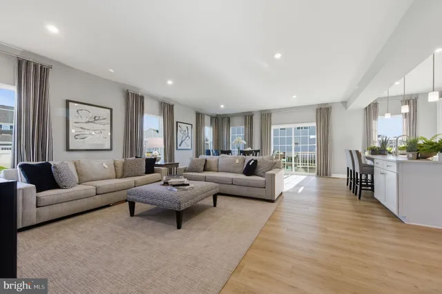 a living room with furniture and view of kitchen