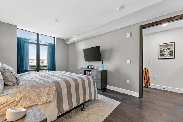 a bedroom with a bed and a flat screen tv