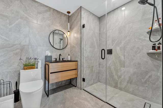 a bathroom with a toilet a sink and a shower