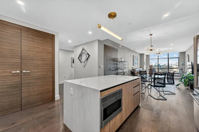 a kitchen with sink cabinets and wooden floor
