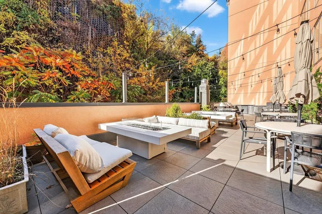 a backyard of a house with table and chairs