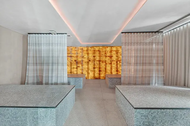 view of hall with wooden floor and door