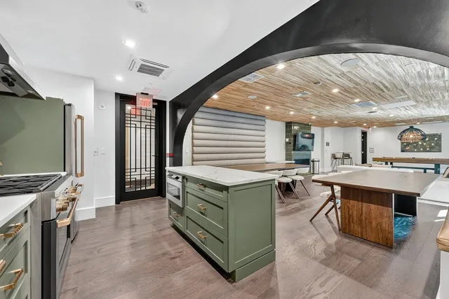 a kitchen with stainless steel appliances granite countertop a stove and a sink
