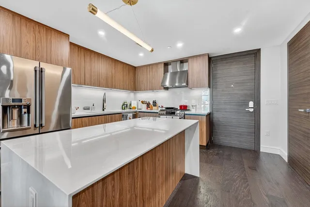 a kitchen with refrigerator and cabinets