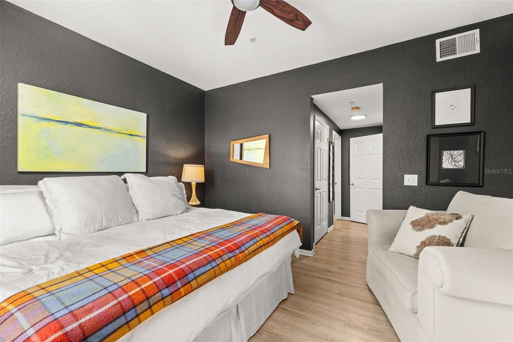 215 Longview Avenue, Unit 104 Celebration, FL 34747 - Photo 16 of 22 a room with a bed and a lamp