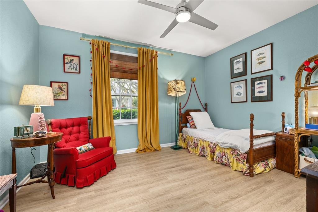 215 Longview Avenue, Unit 104 Celebration, FL 34747 - Photo 19 of 22 a bedroom with a bed and wooden floor