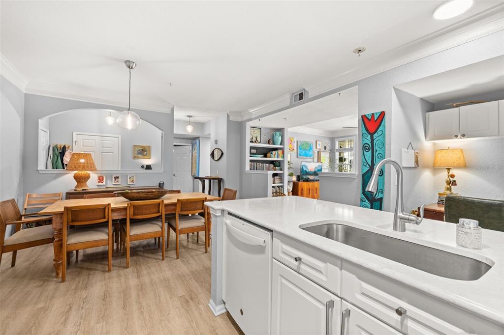 215 Longview Avenue, Unit 104 Celebration, FL 34747 - Photo 7 of 22 a kitchen with a sink cabinets and wooden floor