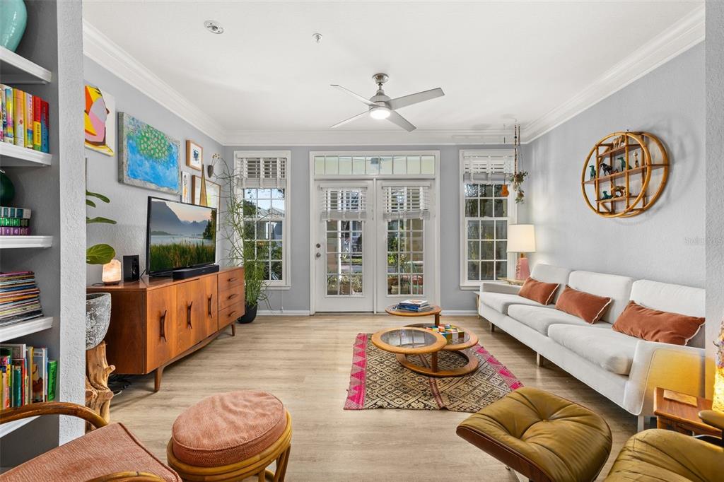 215 Longview Avenue, Unit 104 Celebration, FL 34747 - Photo 9 of 22 a living room with furniture and a flat screen tv