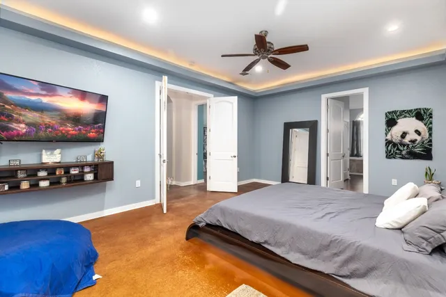 a bedroom with a bed and a chandelier