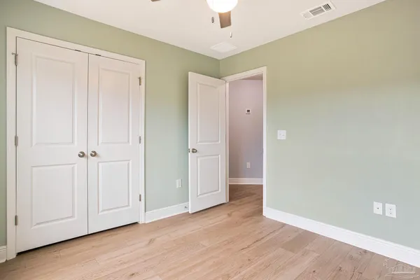 a view of an empty room and wooden floor