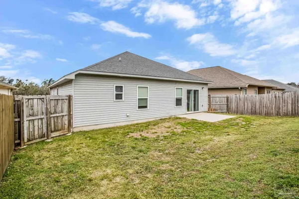 a backyard of a house with wooden fence