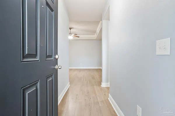 a view of a hallway with wooden floor